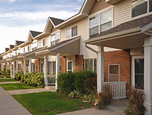 A row of houses with white front porches.