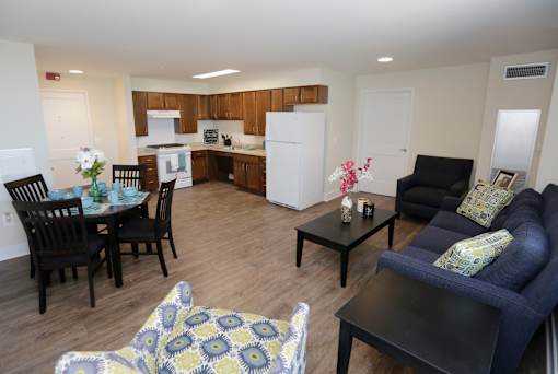 A living room with a dining table and chairs.