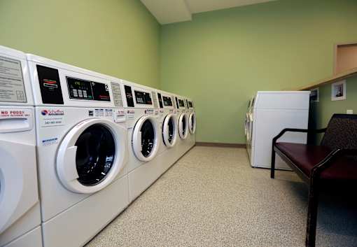 A row of washing machines in a laundromat.