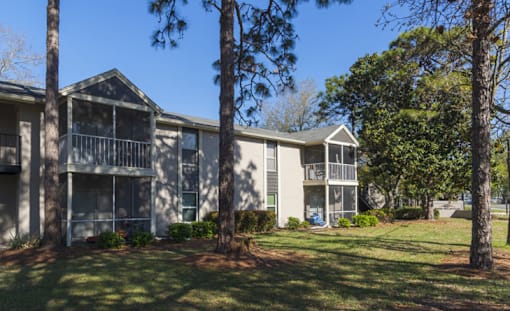 Apartment complex with trees in front.
