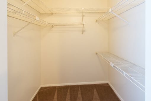Empty white shelves in a room.