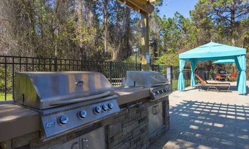 A KRS outdoor grill is on a stone slab.