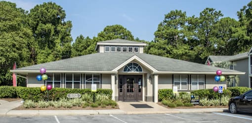 A building with a grey roof and a sign that says "CHRISTIAN" in front of it.