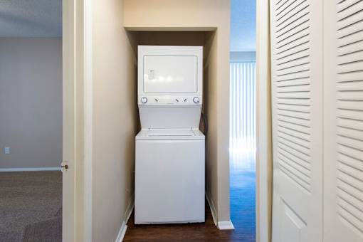 A white washing machine is in a small room.