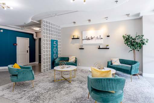Lobby with blue chairs and yellow and green furniture at 500 Fifth Apartments, Nashville, Tennessee
