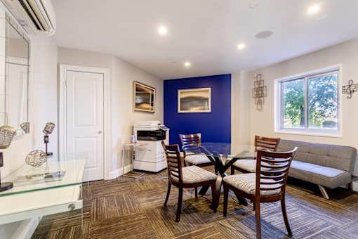 Dining room with a table and chairs and a living room at 500 Fifth Apartments, Nashville, TN