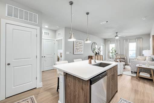 A modern kitchen with a large island and a dining area at The Ashton at East Park Apartments, Kennesaw, 30144