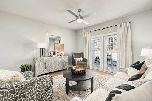 A living room with a black coffee table and a grey sofa at The Ashton at East Park Apartments, Kennesaw, GA, 30144