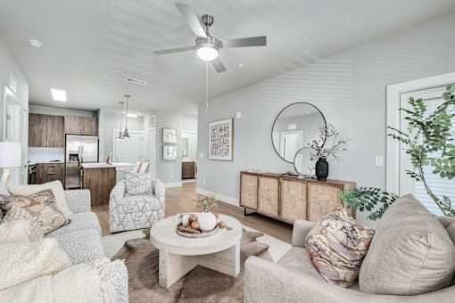 A living room with a white ceiling fan and a white coffee table at The Ashton at East Park Apartments, Kennesaw, GA, 30144