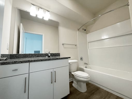 A bathroom with a toilet, sink, and bathtub at Emery Village, Concord, NC