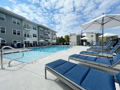 A pool area with sun loungers at Emery Village, Concord, NC