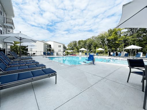 A pool area with sun loungers at Emery Village, Concord, NC