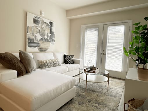 A living room with a white couch at Emery Village, Concord, NC