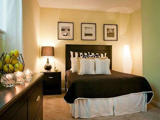 Bedroom with a queen size bed at Emory Woods Apartments, Durham, NC.