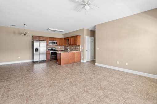 A kitchen with a living room access, microwave, and oven. at The Lory of Greenway Village Apartments, Ky
