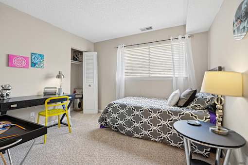 Spacious bedroom with desk and natural light at The Palms Apartments, Charleston, South Carolina