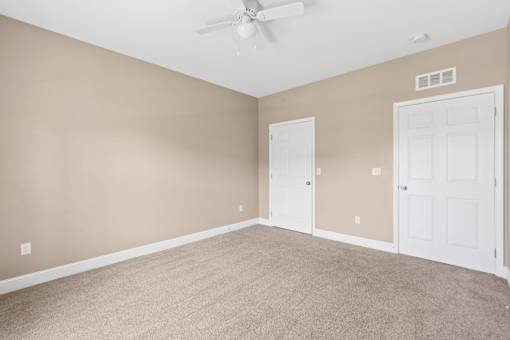 Spacious bedroom with ceiling fan and carpet at The Lory of Greenway Village Apartments, Kentucky, Kentucky
