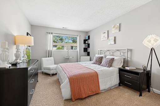 Bedroom with modern furniture and natural light at The Palms Apartments, South Carolina