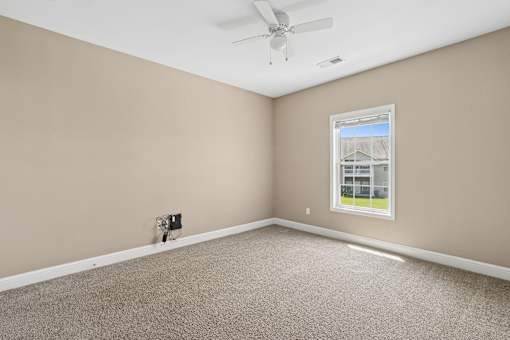 Empty bedroom with carpet and ceiling fan at The Lory of Greenway Village Apartments, Kentucky