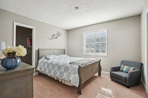 Bedroom with a bed and a chair and a window  at Cape Landing, Myrtle Beach, South Carolina