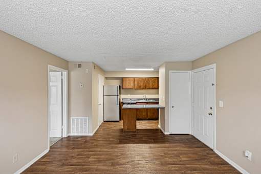 A kitchen with white cabinets and a wooden island.