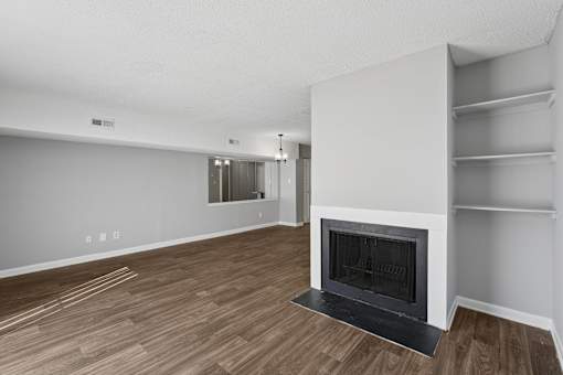 A modern living room with a fireplace and wooden flooring.