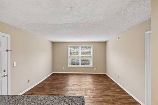 A room with a window and a door.