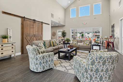 Community room with barn doors and patterned furniture at The Lory of Greenway Village Apartments, Kentucky, KY 42001