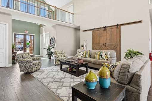 Clubhouse seating area with sliding barn doors at The Lory of Greenway Village Apartments, Kentucky, KY