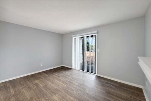 Living room with a sliding glass door to a patio  at Governors House, Huntsville, AL, 35805