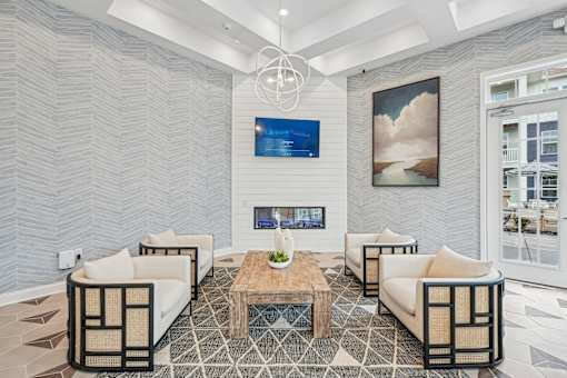 A modern living room with a fireplace and a painting on the wall.