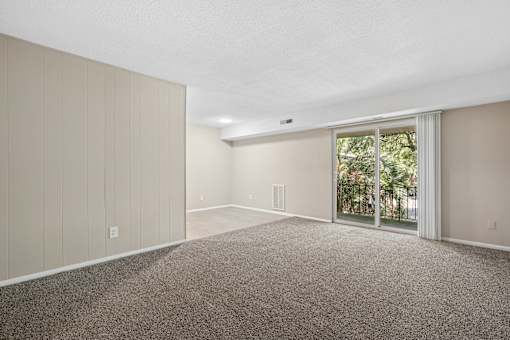 Spacious living room with patio access at The Palms Apartments, Charleston, SC 29407