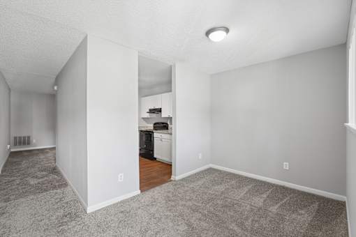 A kitchen area with a dishwasher and a refrigerator.