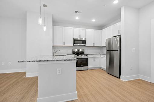 Modern kitchen with breakfast bar and granite peninsula at The Palms Apartments, Charleston, South Carolina