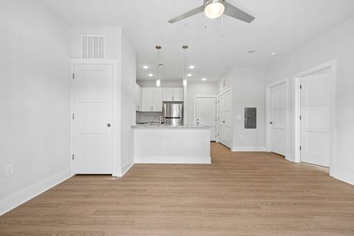 Open living space with vaulted ceiling and pendant lights at The Palms Apartments, Charleston, SC 29407