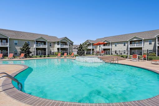 A large swimming pool in front of apartment buildings. at The Lory of Greenway Village Apartments, Ky