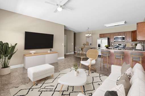 A living room with a white couch and a black television. at The Lory of Greenway Village Apartments, Ky