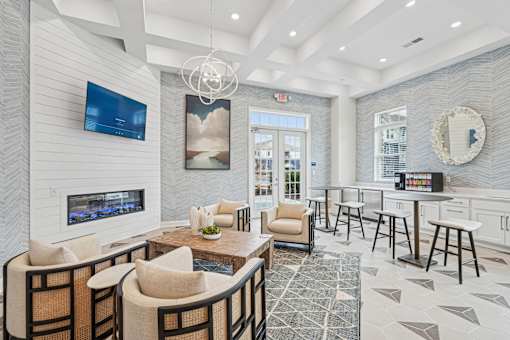 A modern living room with a fireplace and a flat screen TV.