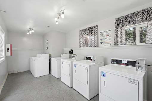 A laundry room with washing machines and a window.