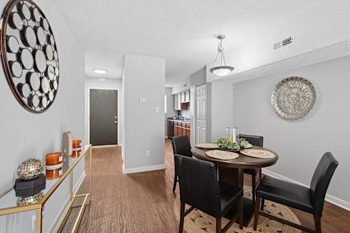 A dining room with a round table and chairs.