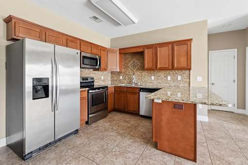 Kitchen with stainless appliances and granite counters at The Lory of Greenway Village Apartments, Kentucky, 42001
