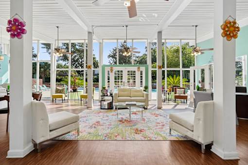 Bright clubhouse lobby with floor to ceiling windows at The Palms Apartments, South Carolina