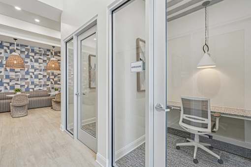 A room with a glass door leading to a balcony.