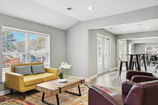 Living room with a yellow couch and a coffee table   and a kitchen  at Emerald Bay, North Carolina