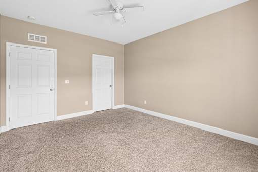 A room with beige walls and carpeted floor with a ceiling fan. at The Lory of Greenway Village Apartments, Ky