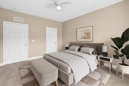 A bedroom with a large bed and a ceiling fan. at The Lory of Greenway Village Apartments, Ky