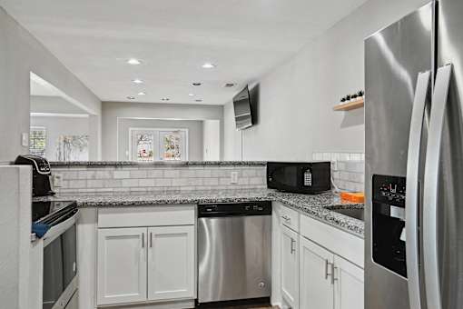 Kitchen with stainless steel appliances and granite counter tops at Emerald Bay, Charlotte