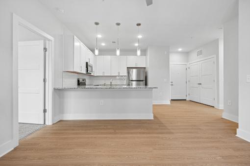 Open plan kitchen with breakfast counter and pendant lights at The Palms Apartments, Charleston, South Carolina