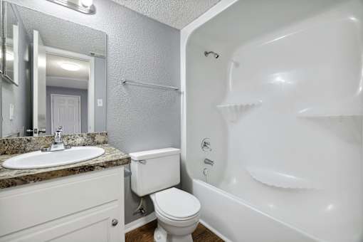 Bathroom with a sink toilet and a bath tub  at Governors House, Huntsville, AL