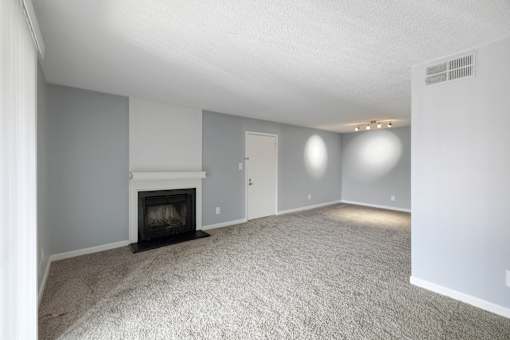 Living room with a fireplace and white carpet  at Governors House, Alabama, 35805